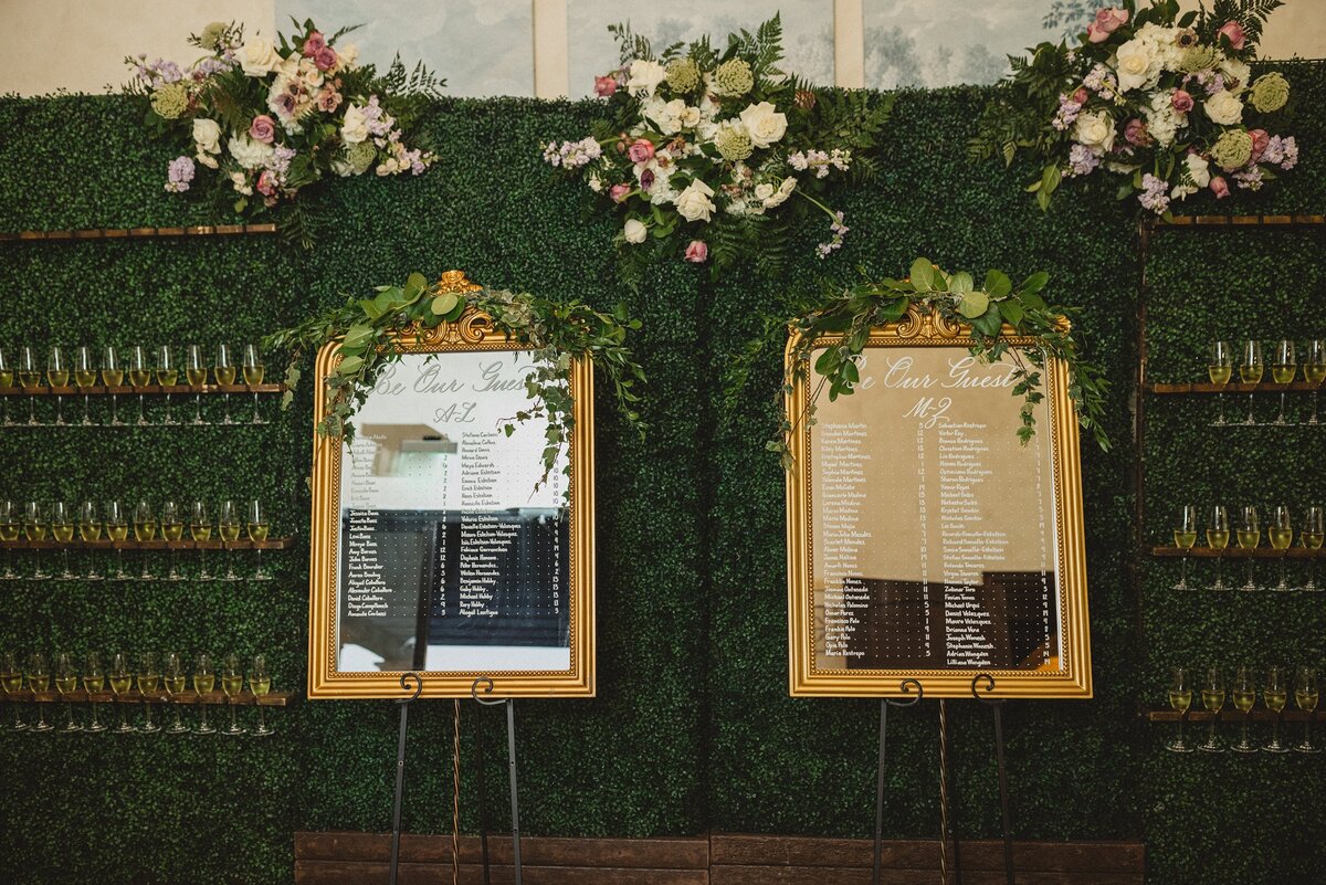 Medium vertical mirror with ornate ornament on top with calligraphy for seating chart