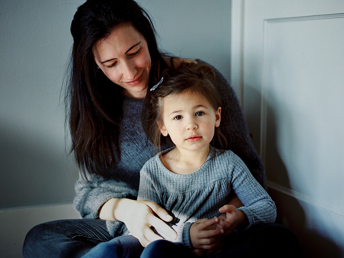 a daughter sits in front of her mom
