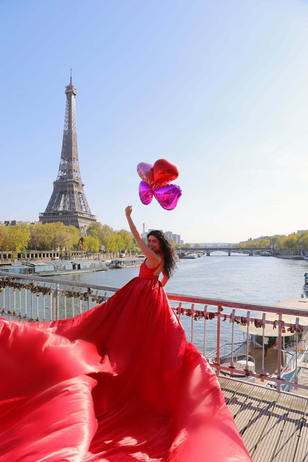 women having a portrait photoshoot in paris wearing a red flying dress