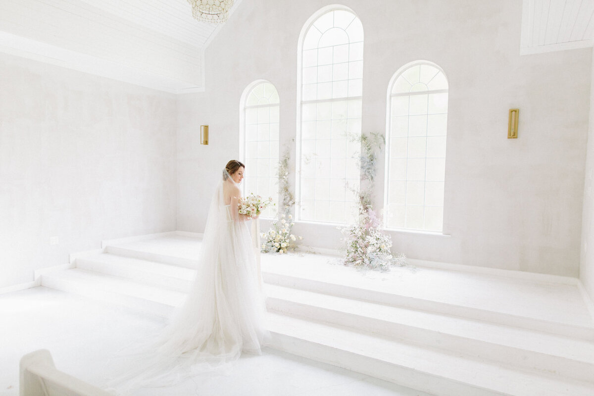 Bride standing at the stage in an all-white room