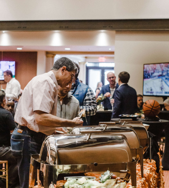 people getting food at a buffet at a corporate event dinner