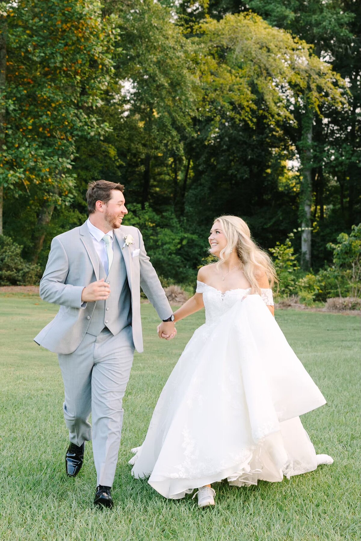 Bride and groom running and smiling
