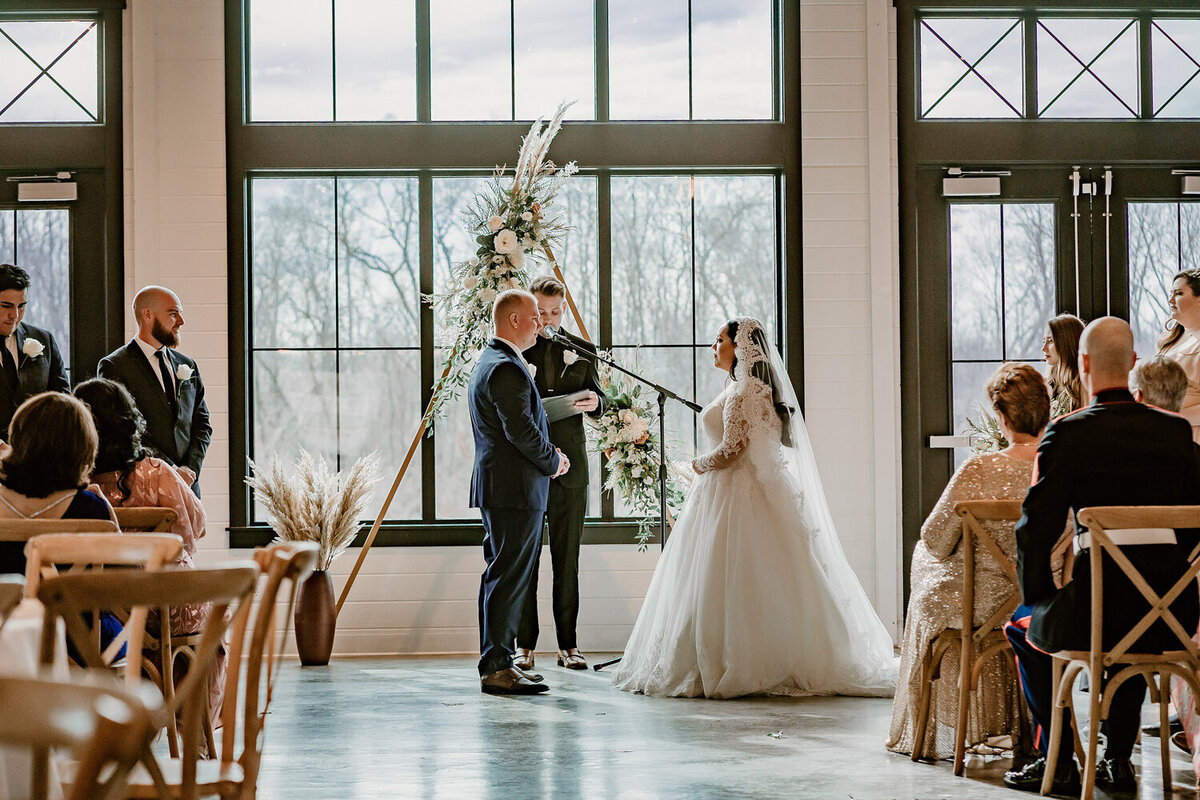 bride-and-groom-vow-exchange-modern-wedding-venue-ashton-hill-farm-cedar-rapids-iowa-storyteller-collective-photo-co