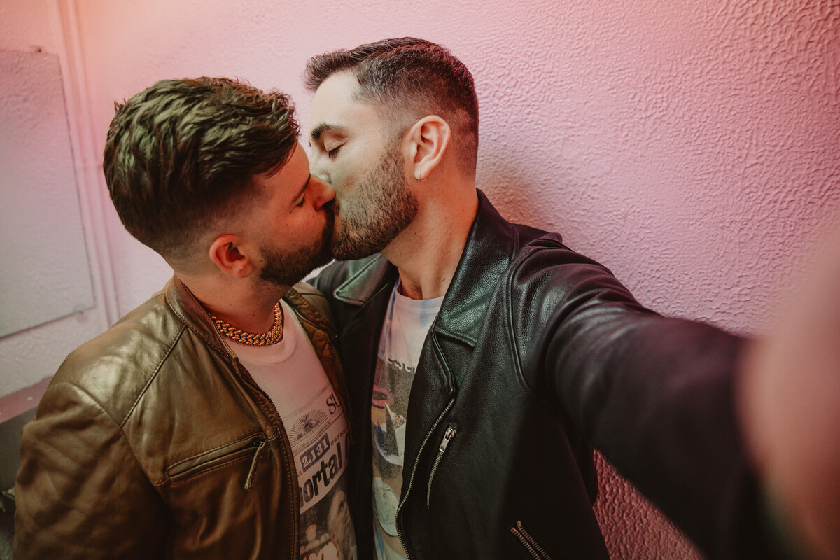 A couple taking a selfie as they kiss