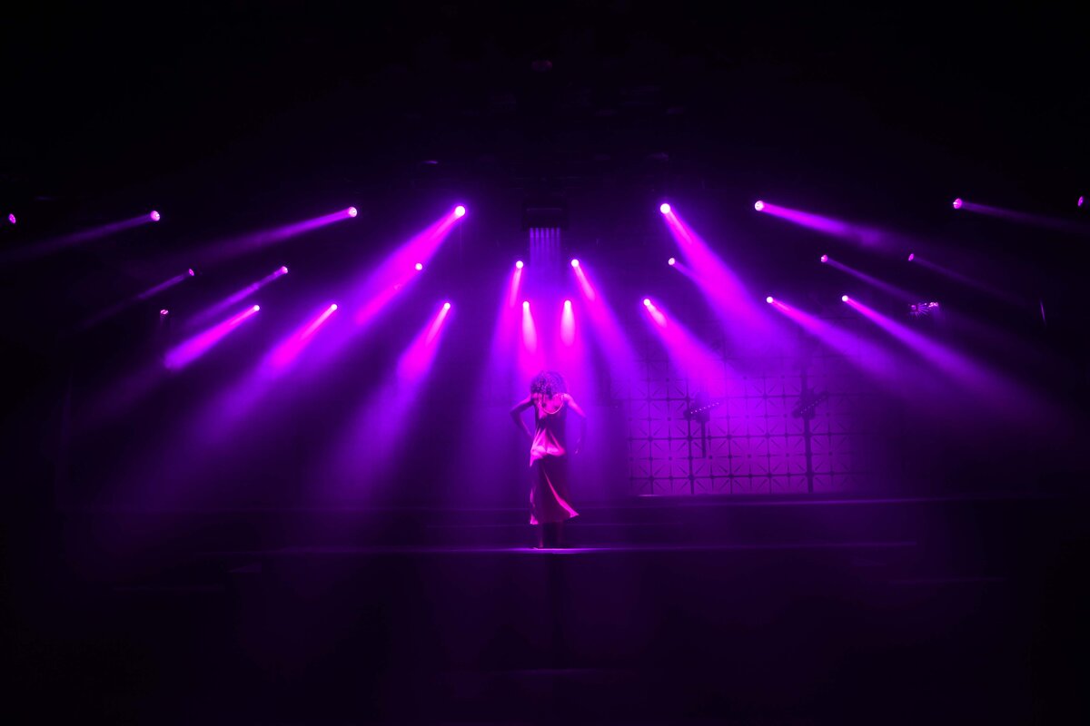 Purple lights are used to create drama for modern dancer in San Diego CA