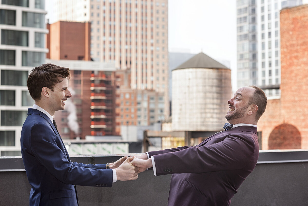 A couple dancing and smiling on a rooftop