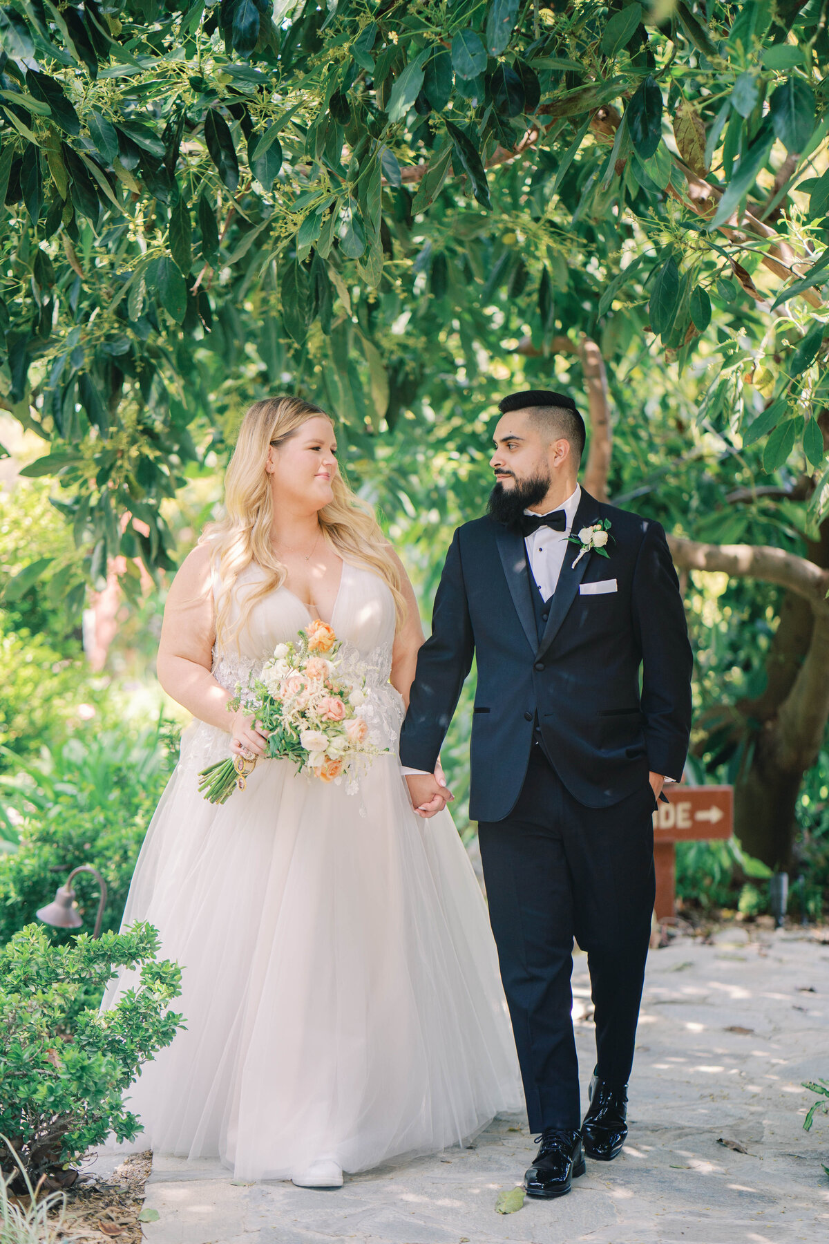 a bride and groom face each other and kissing on their wedding day in  camarillo califfornia