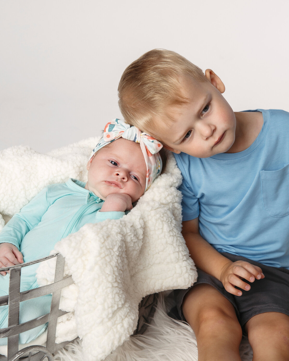 Sweet portrait of a brother and baby sister taken in the studio near Janesville, Wisconsin