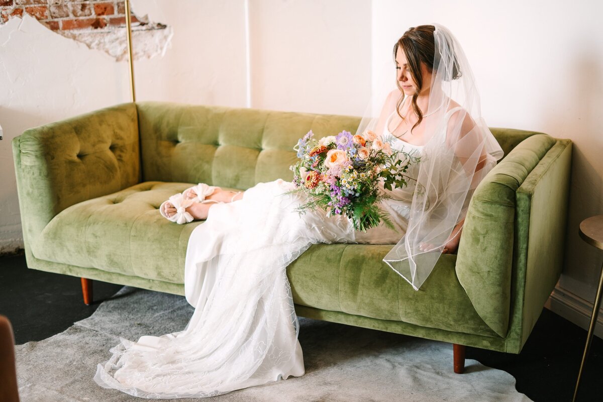 Bride before her wedding ceremony with a colorful bouquet at Moss Denver.