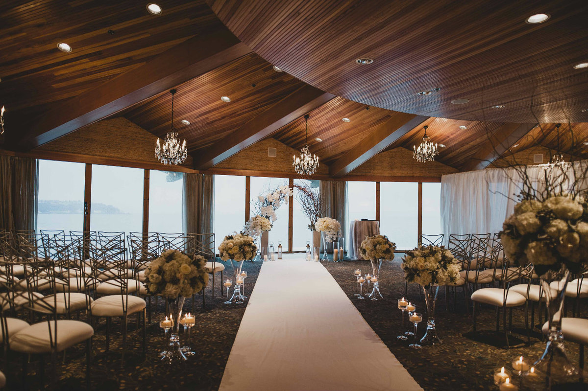 Luxury white winter wedding ceremony with white floral lining the ceremony aisle