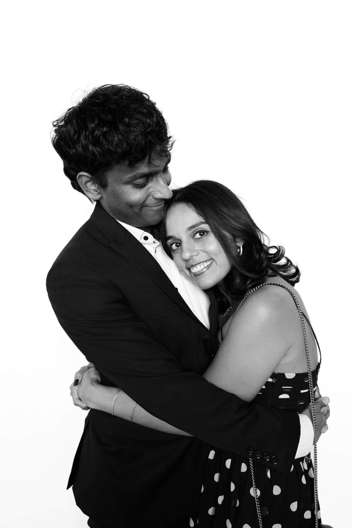 A sweet embrace captured in a black and white portrait by Monochrome Portraits, blending modern photo booth style with timeless Phoenix elegance.