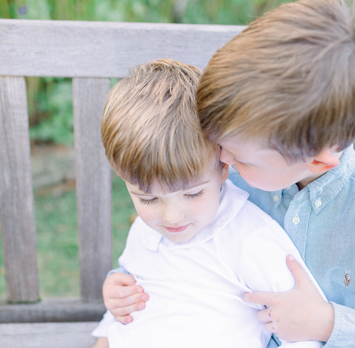 brothers sitting on bench taking by birmingham family photographer