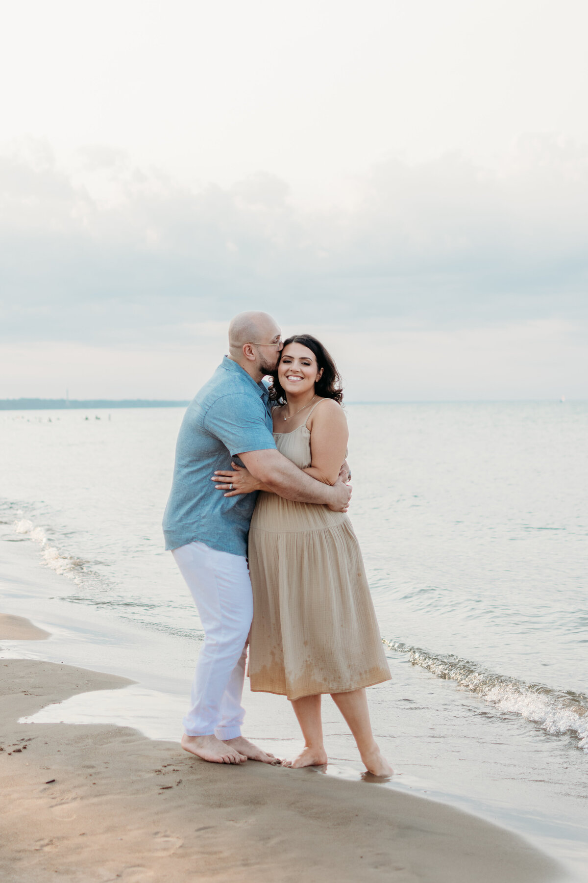 Mom and Dad share a moment during a family photo session by Lake Michigan