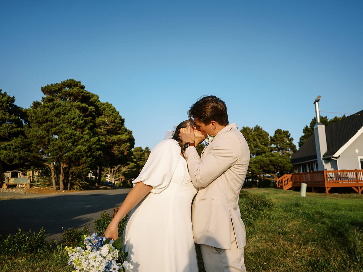 A bride and groom kissing.