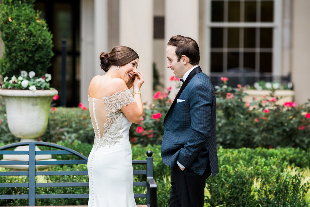 A bride is moved to tears after the first look with her groom at the Biltmore Ballrooms in Atlanta
