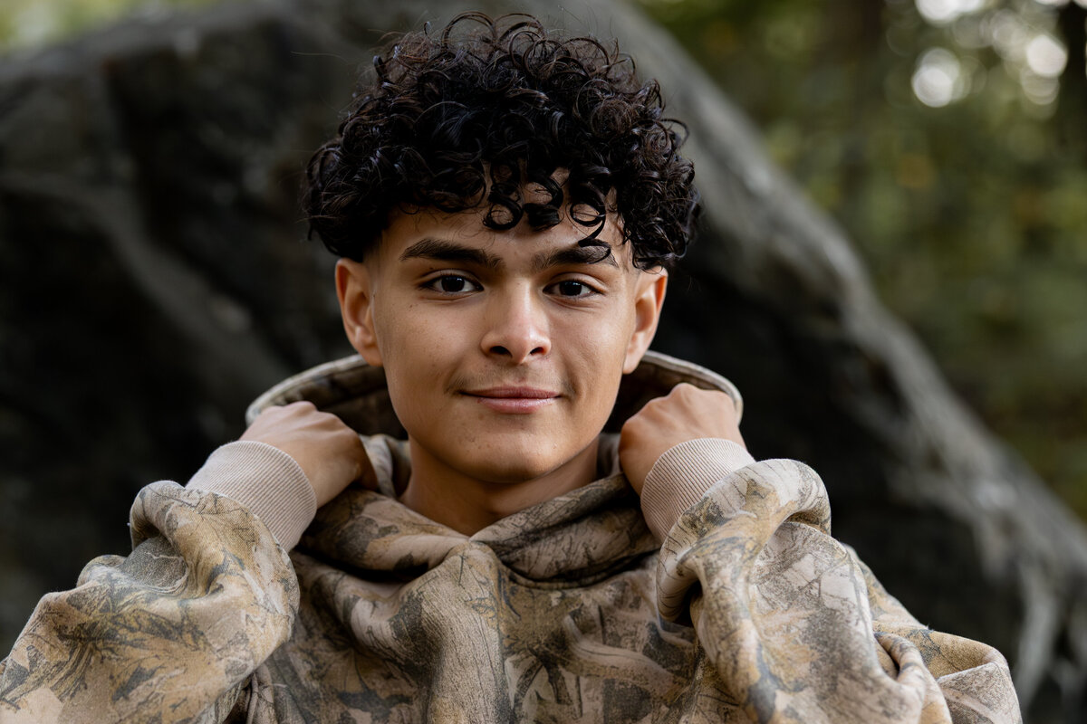 Photo of a group of football players from behind standing on the sidelines