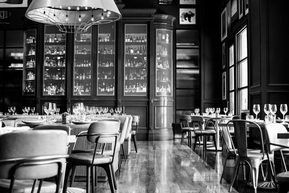 Black and white image of the dining room at the Libertine Social