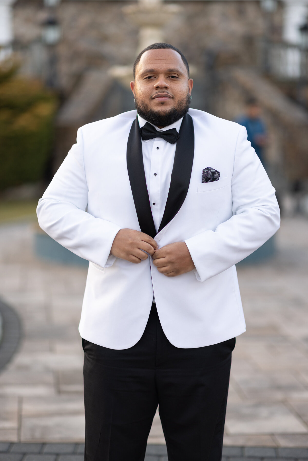 Groom in white suit jacket