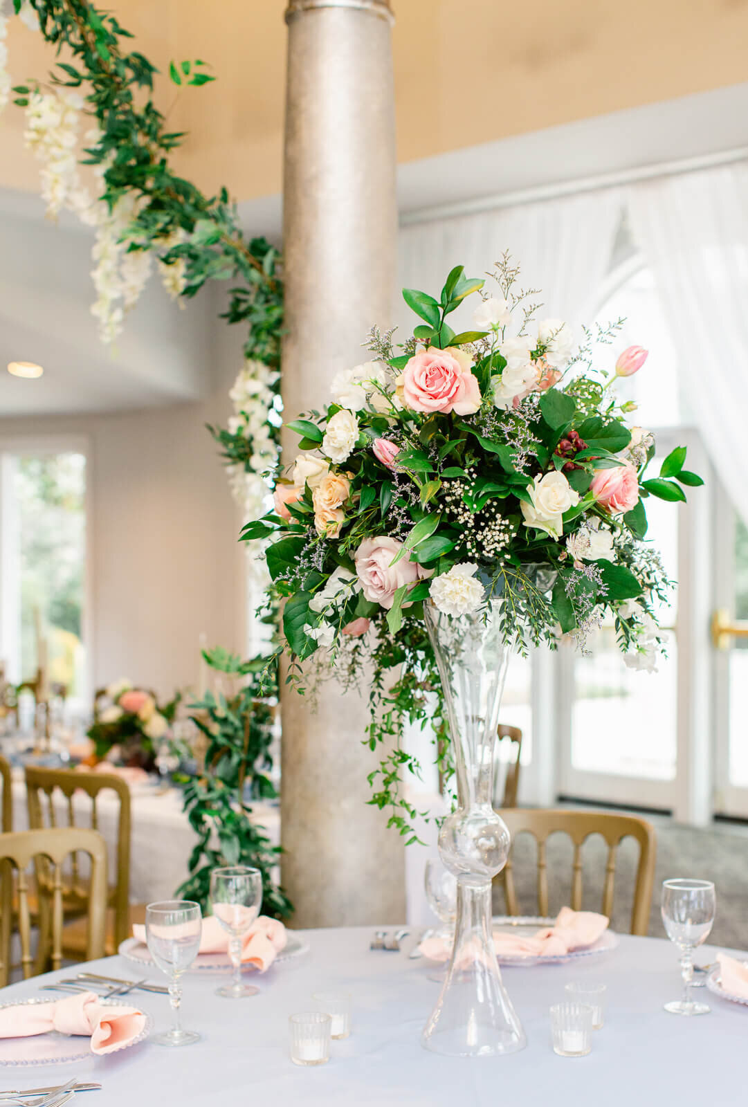Tall floral centerpiece with peach and pink pastel florals at Ceresville Mansion. Captured by Bethany Aubre Photography.