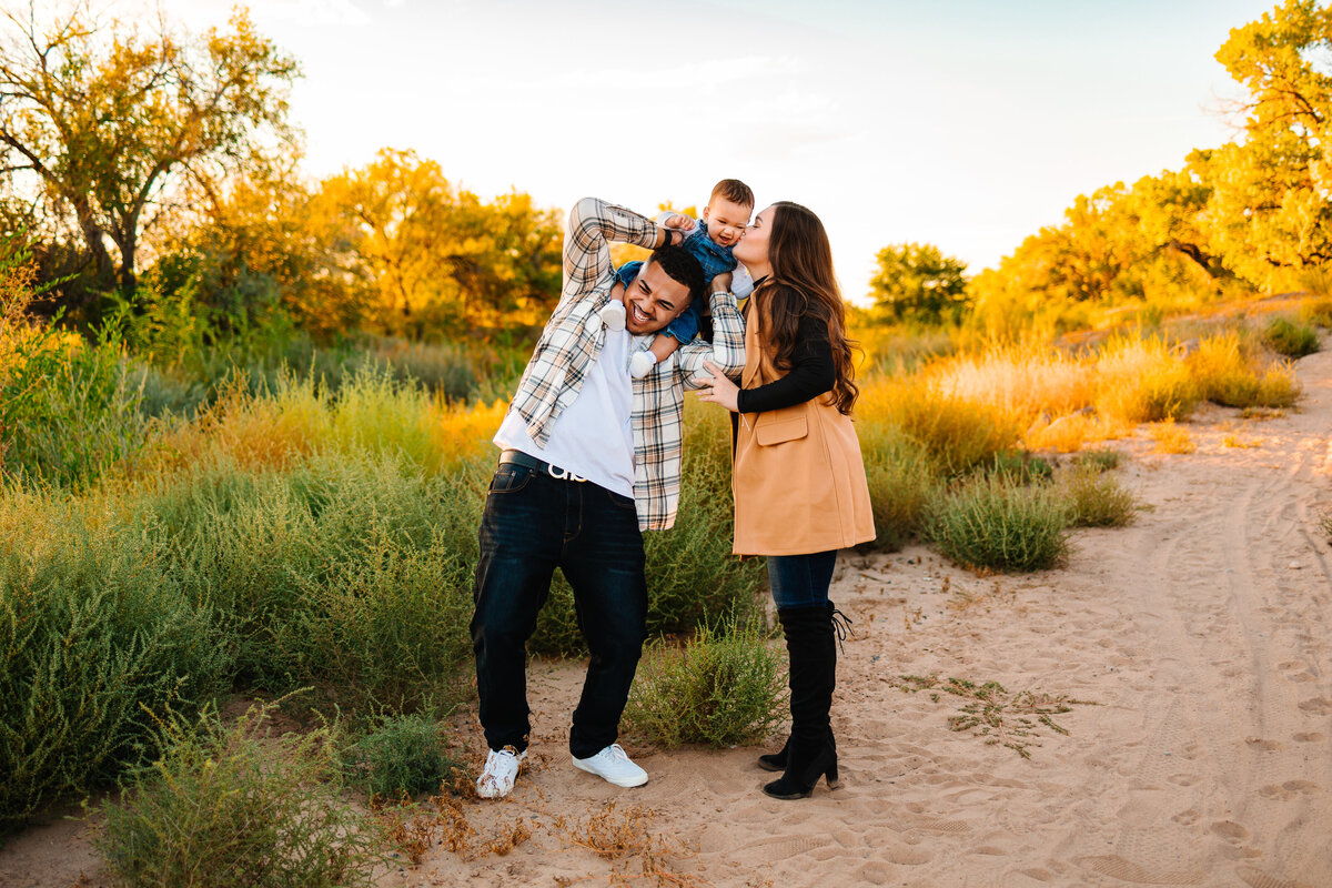 A family of 3 in Santa Fe enjoying a fall mini session at the bosque.