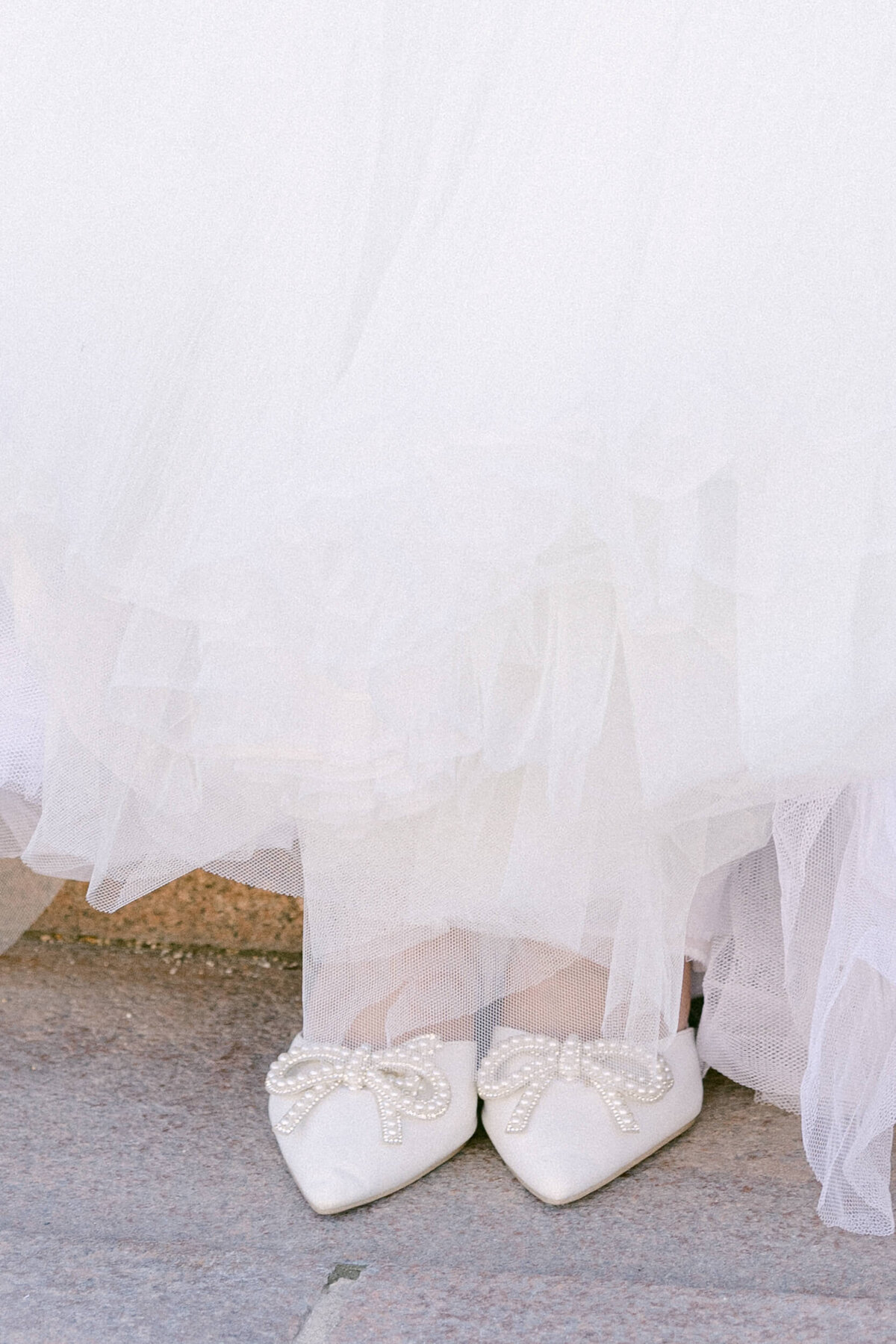A wedding photo of a bride in her white dress in the streets of Paris in France.