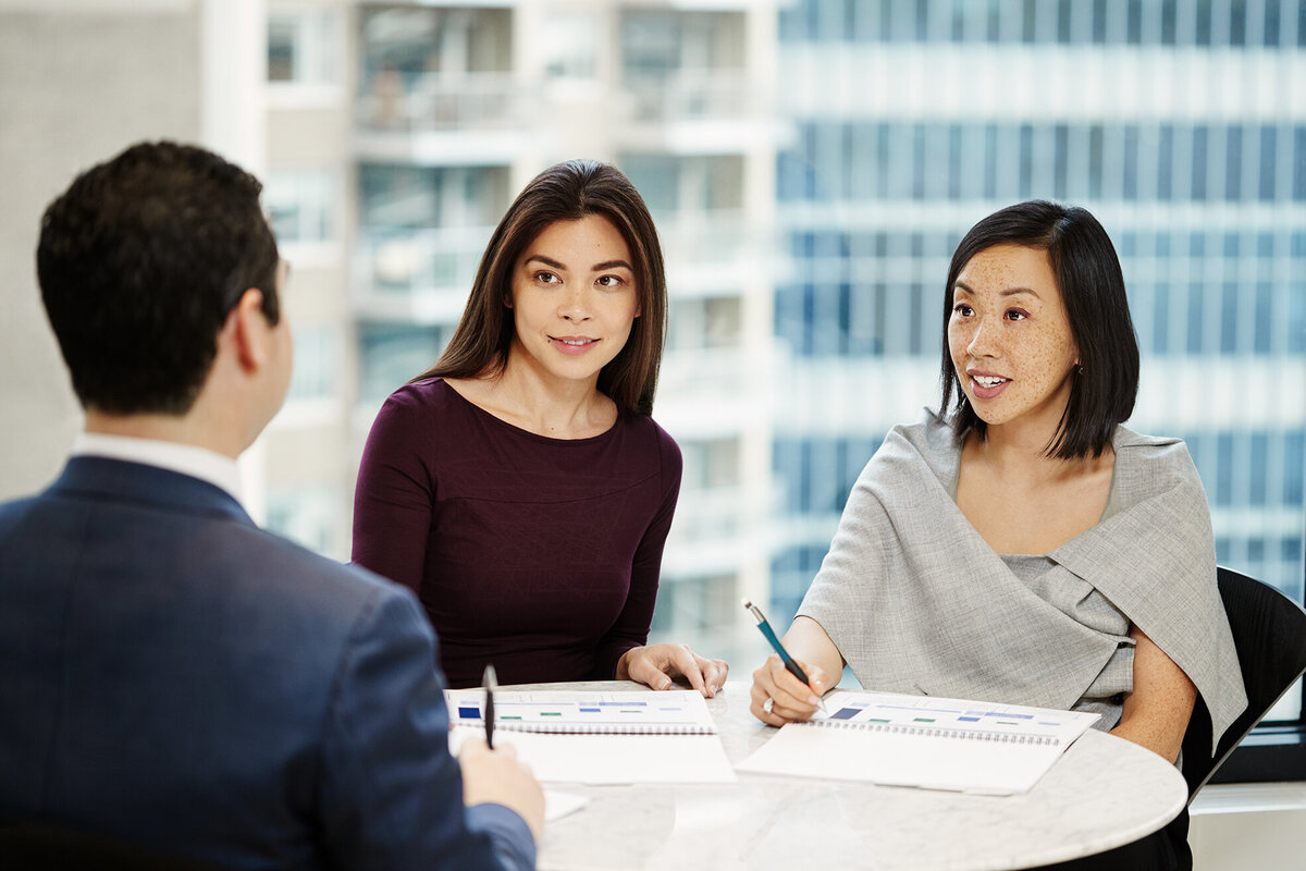 Professional discussion between two individuals in Cornell Capital Offices, captured by Ylva Erevall.