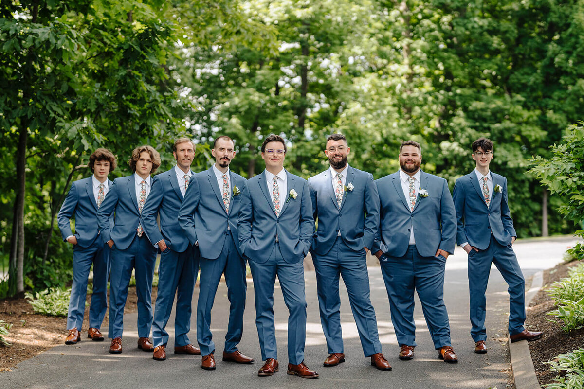 Groom with groomsmen wearing blue suits at Oswego wedding, NY