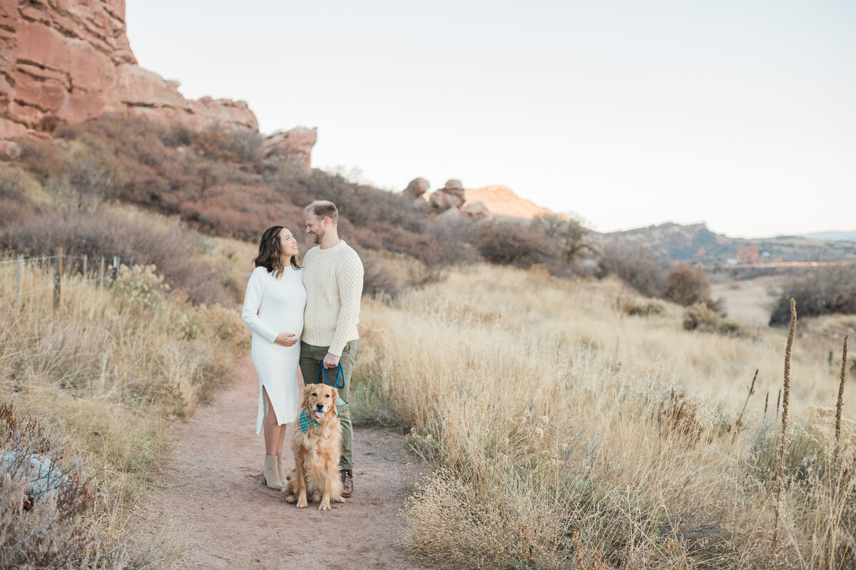 An expecting couple with their dog at South Valley Park in Littleton