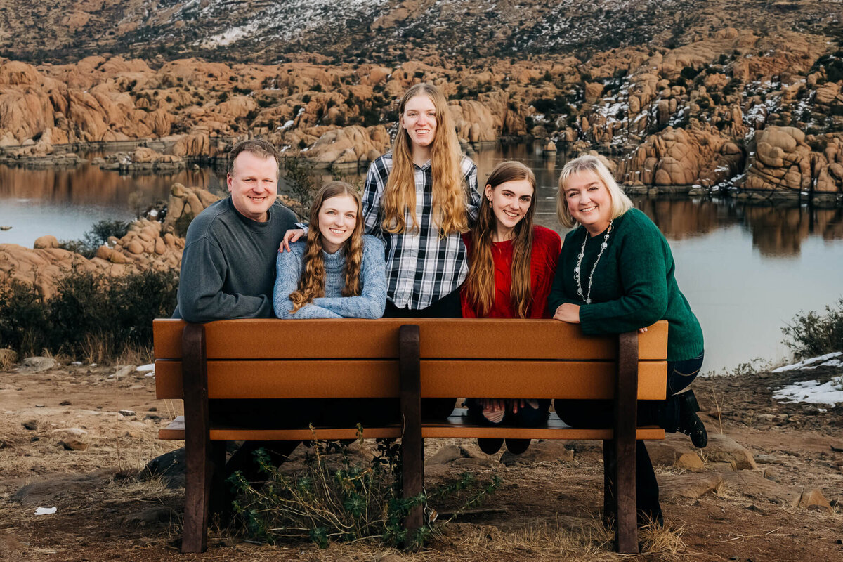 Family poses on bench overlooking Watson Lake in Prescott family photos by Melissa Byrne