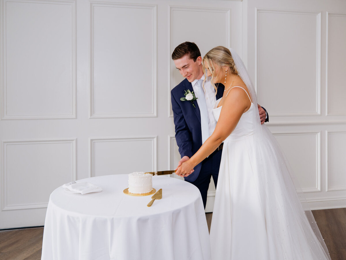Couple cutting wedding cake at their Cleveland Yachting Club wedding reception