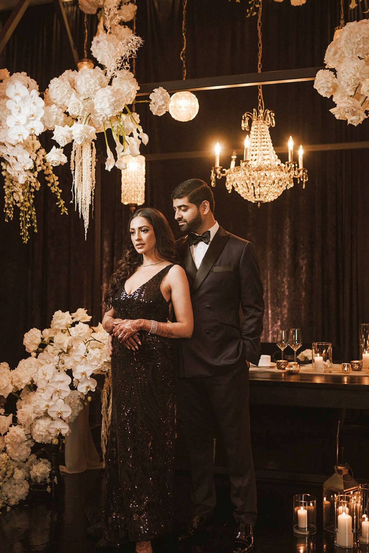 black-white-gold-wedding-reception-chandelier-bride-groom-flowers-candle
