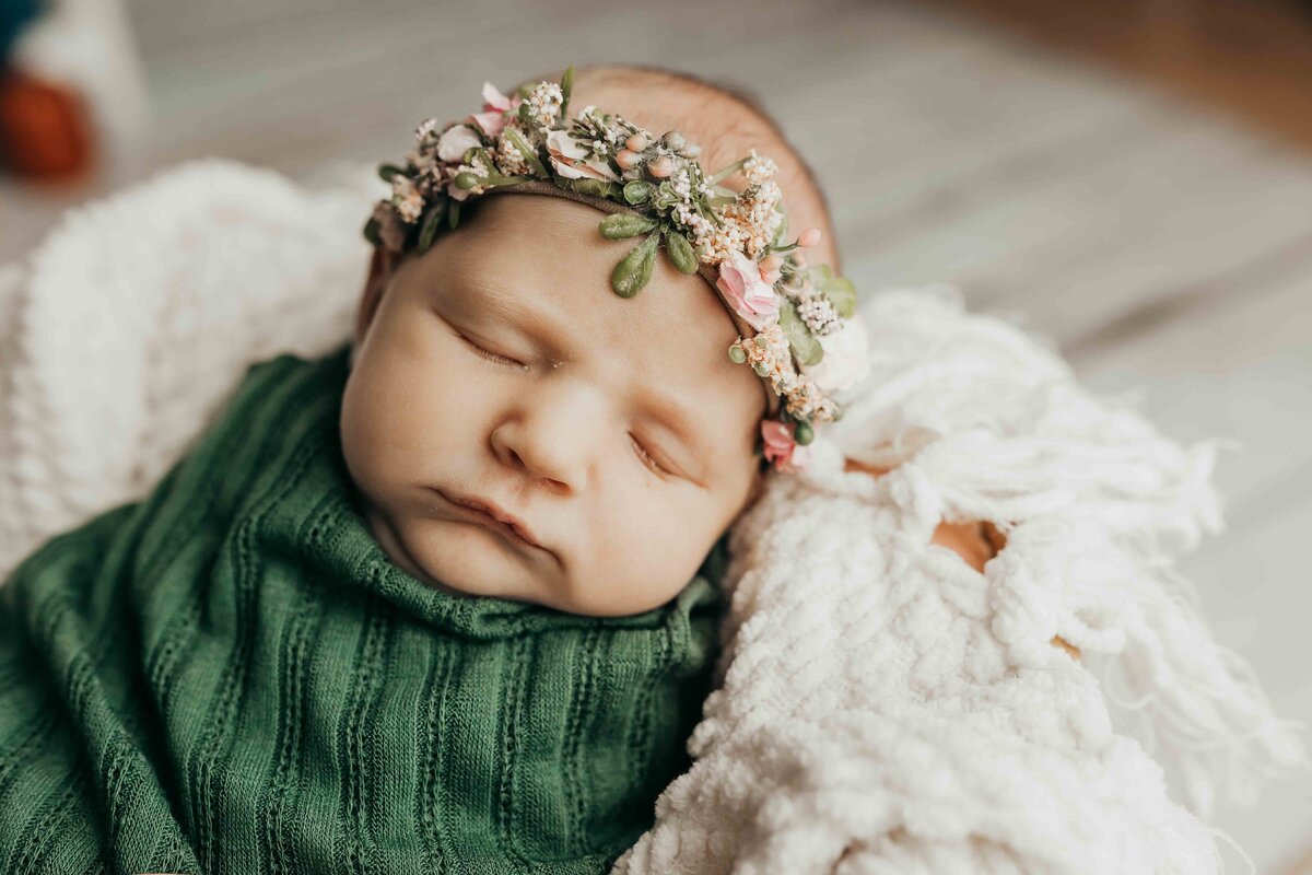 baby girl with floral headband swaddled by harrisburg pa newborn photographer