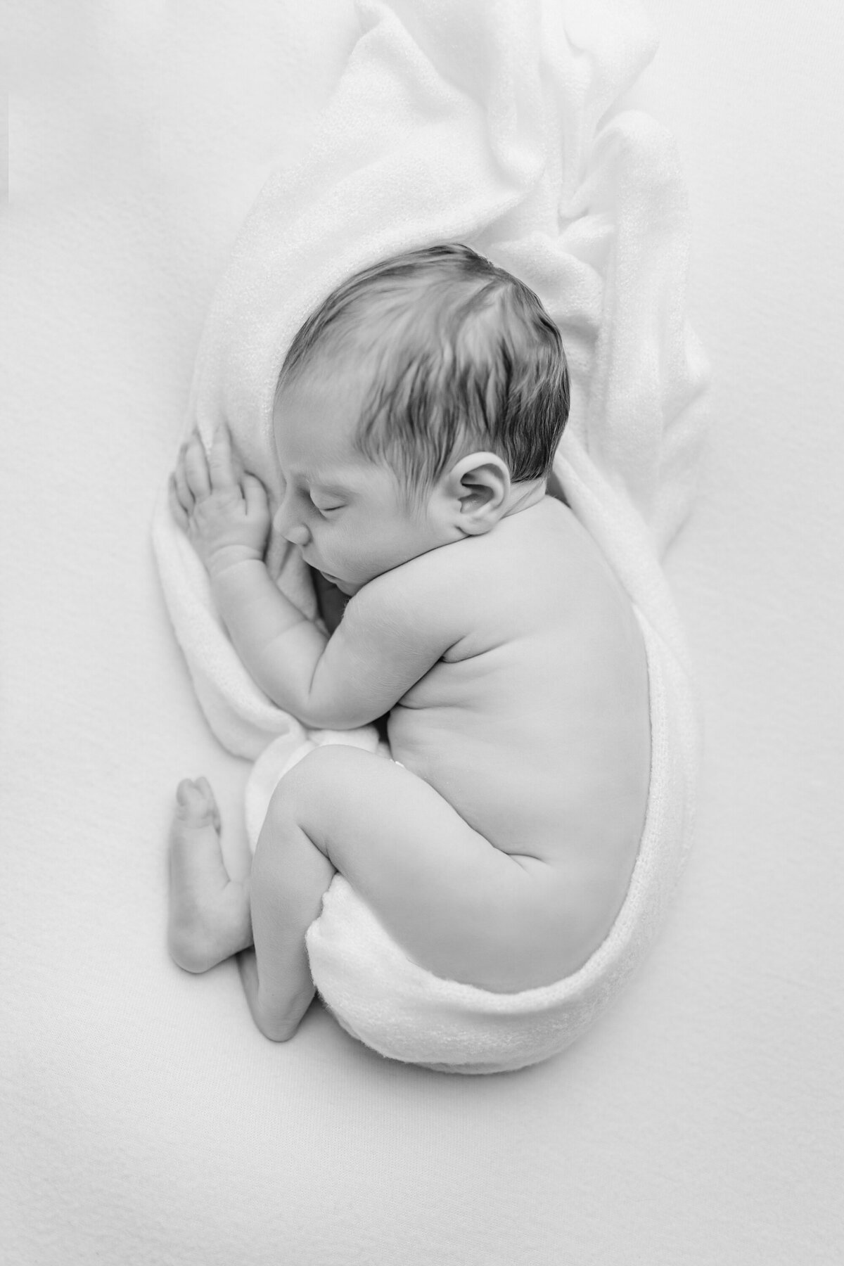 newborn baby swaddled the womb