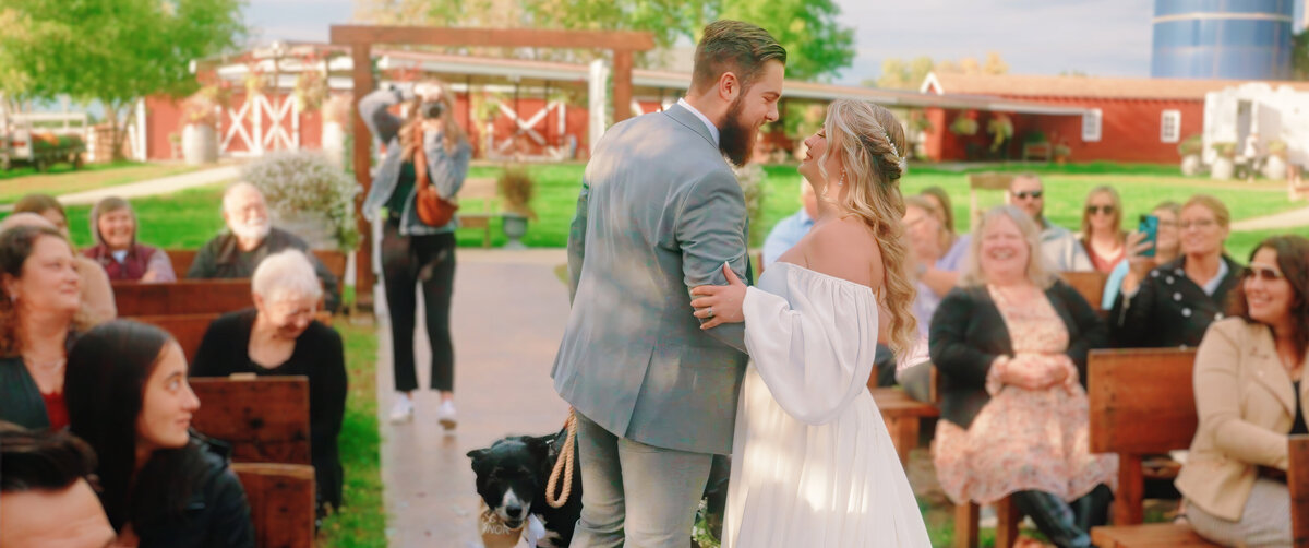 Bride and groom about o kiss on outdoor aisle 