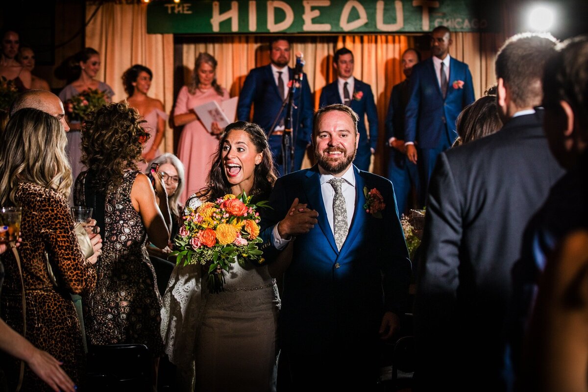 A couple leaves their ceremony at a Hideout Chicago wedding.