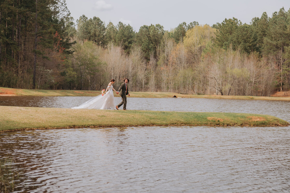 Newlyweds walk along the lakefront