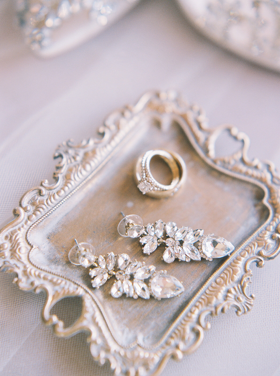 silver wedding jewelry on a silver tray