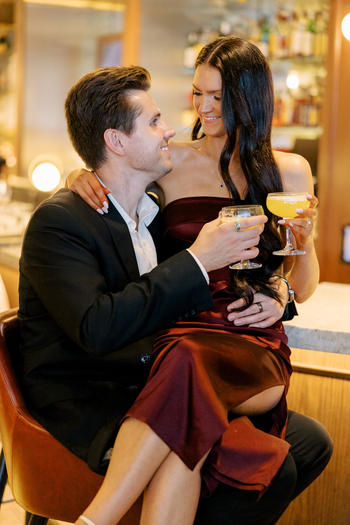 A couple enjoys cocktails at the chic bar inside Venteux in downtown Chicago, captured in an elegant and stylish engagement session.