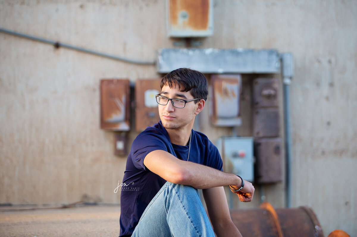 Senior boy sitting looking off in the distance