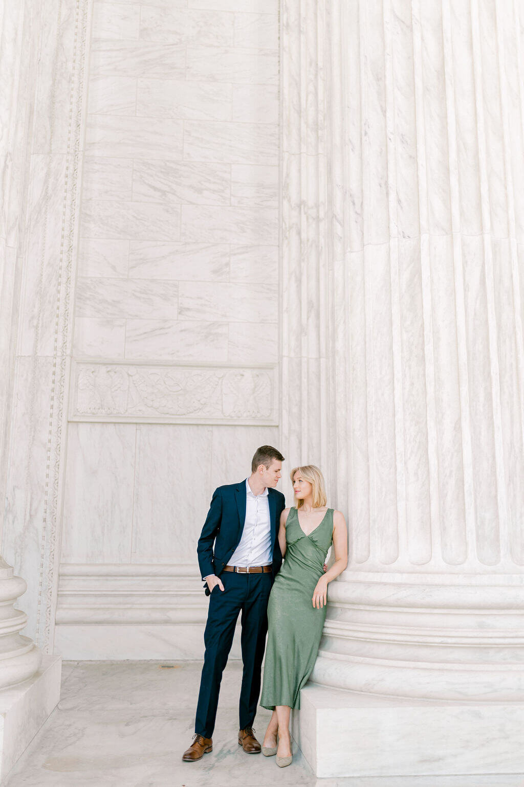 Photo of a chic couple leaning against the columns of the US Supreme Court in DC