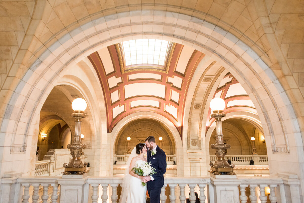 couple poses under arch old courthouse celveland
