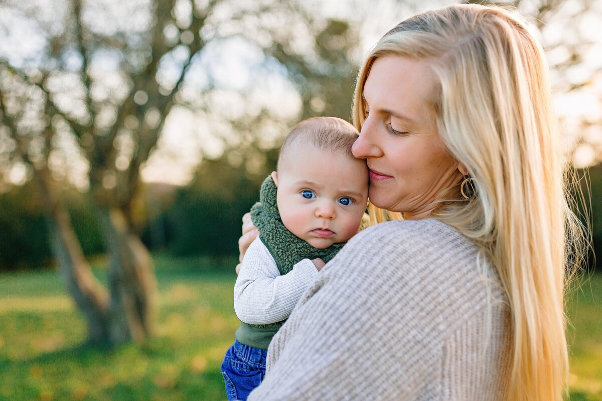 Mom kissing son family photography
