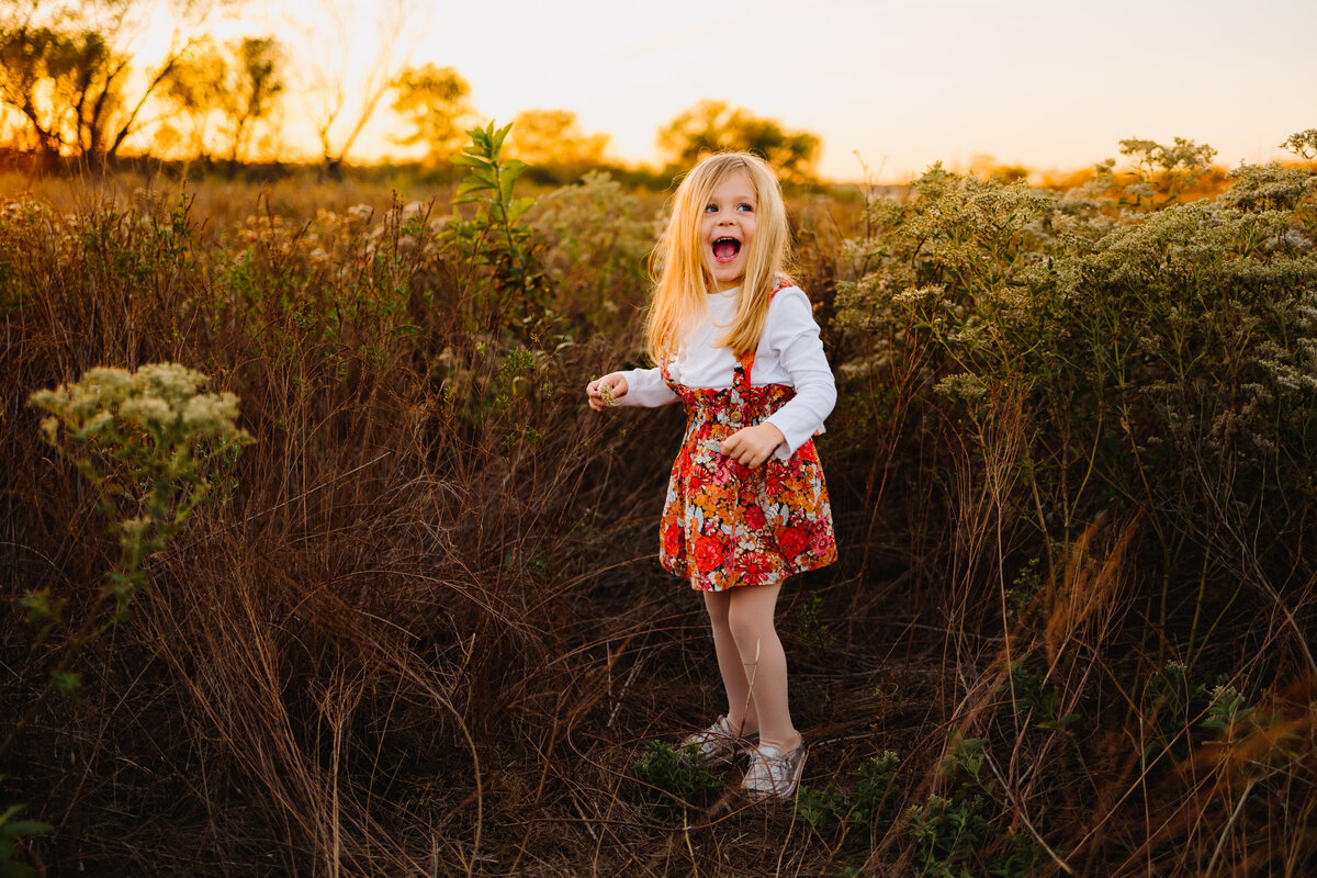 Albuquerque family portrait featuring a joyful little blond girl in a beautiful flower-patterned short dress.