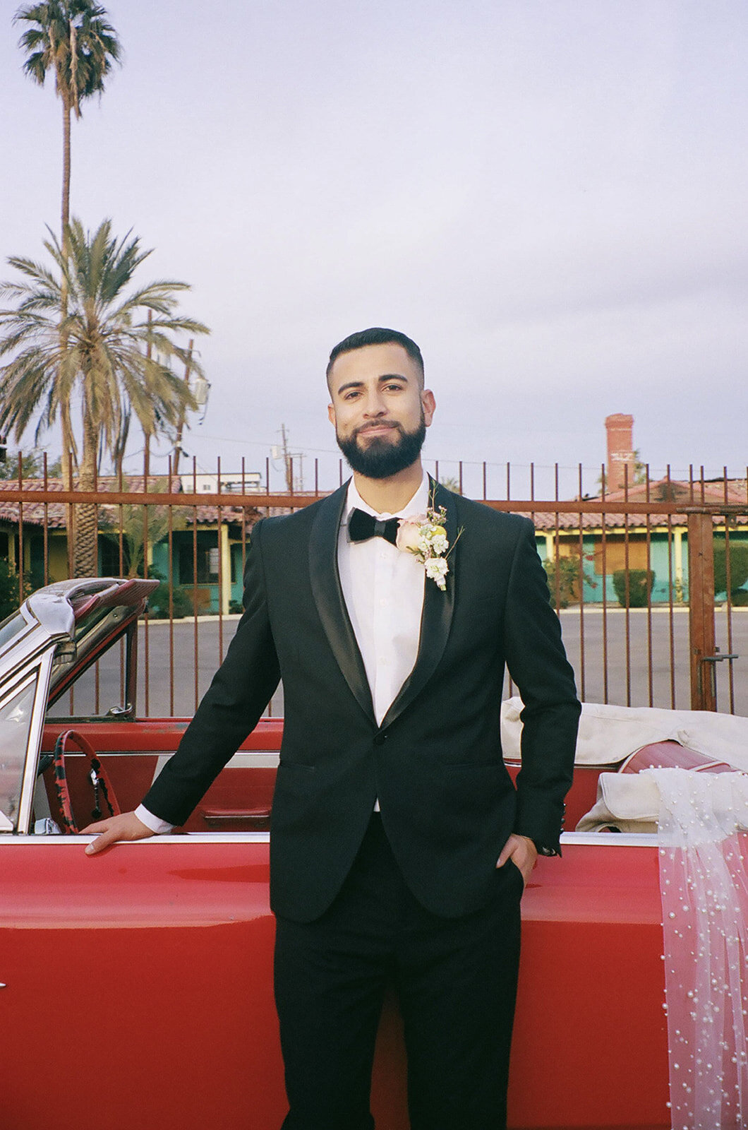 Groom standing with classic car for Las Vegas Elopement