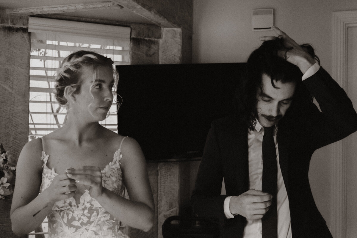 Couple getting ready together for their intimate family wedding in their vacation rental in Big Sur, California