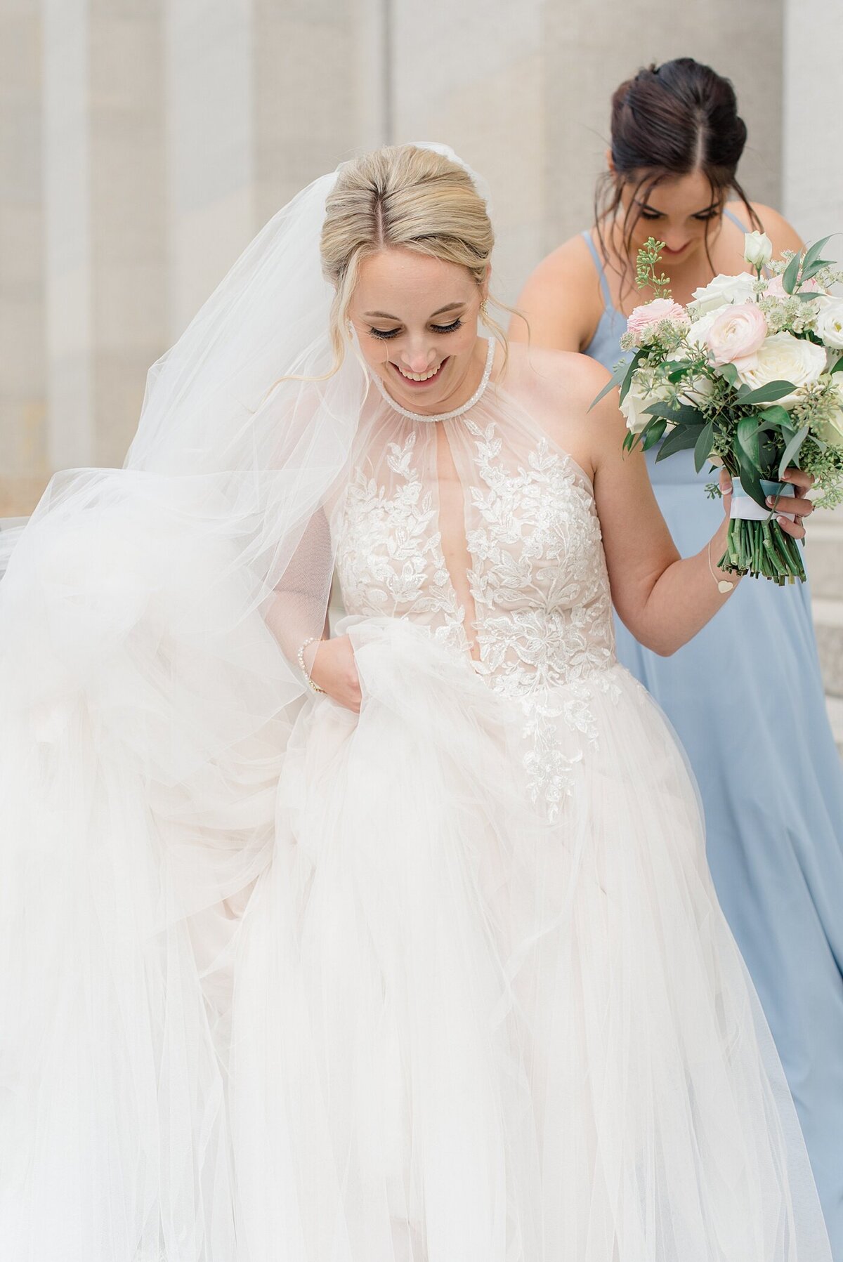 Bride walks in wind outside of Ohio State House photographed by Ohio Wedding Photographer
