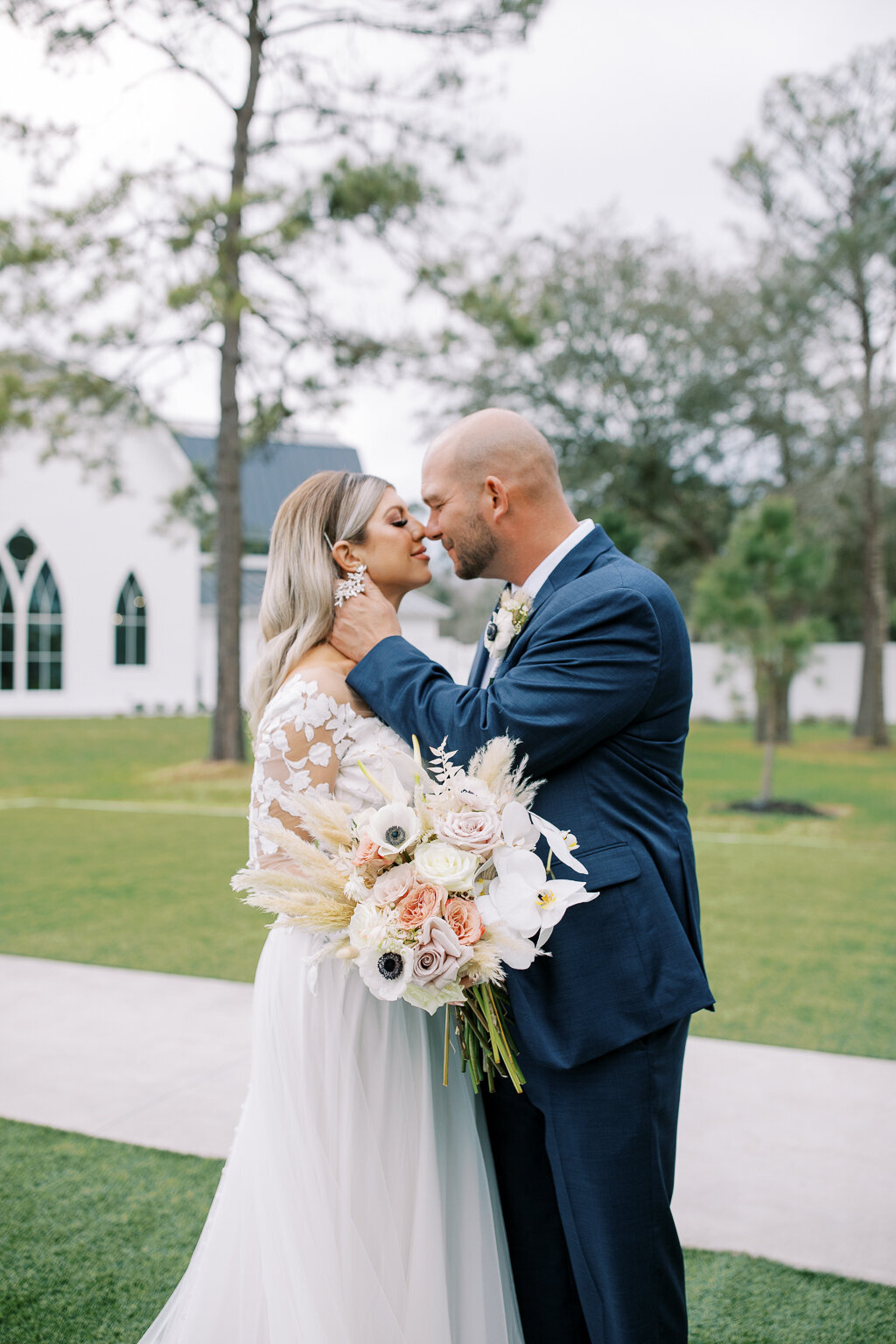 Wedding Photography, man about to give wife a kiss in front of white estate