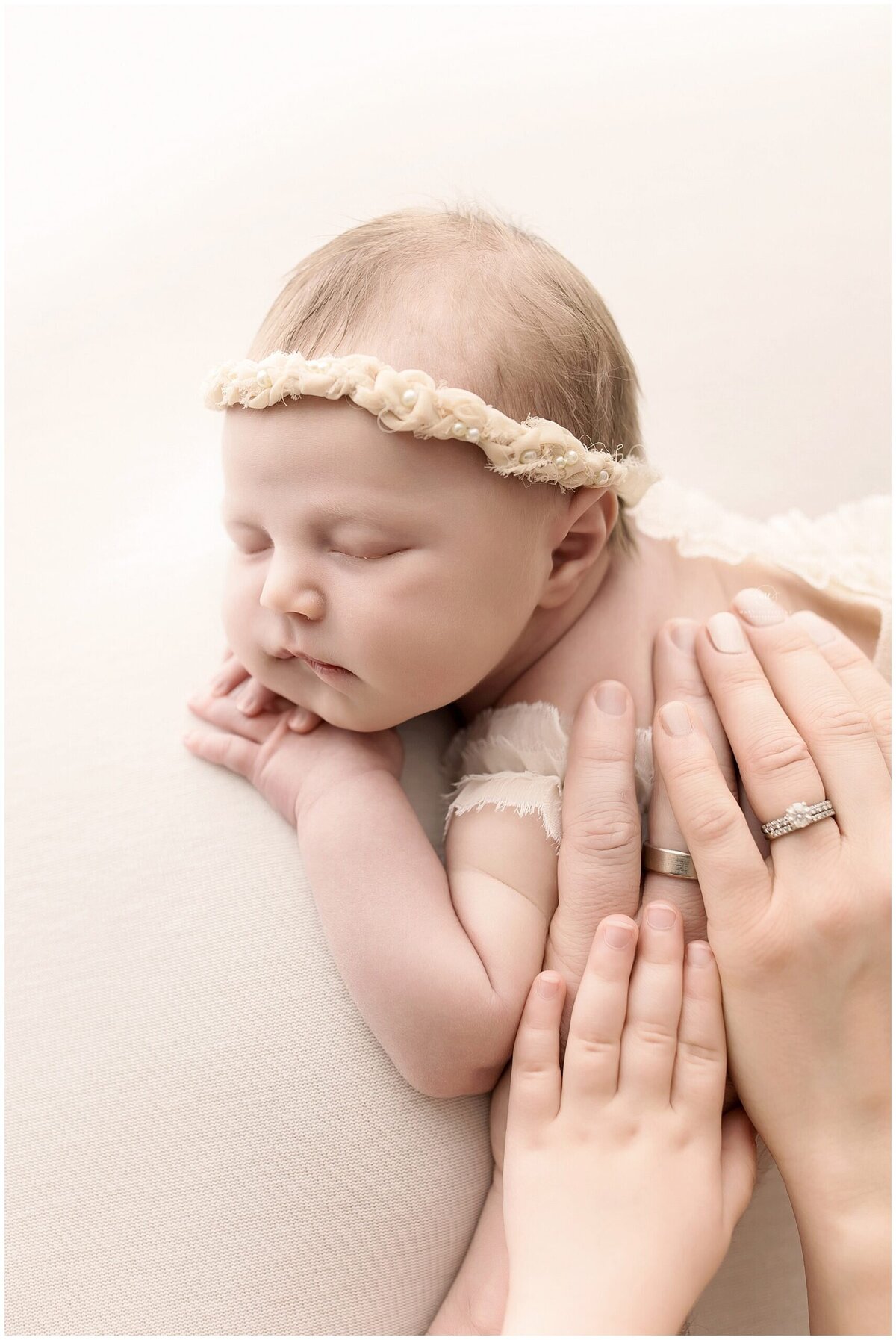 An Akron family places hands on their newborn baby