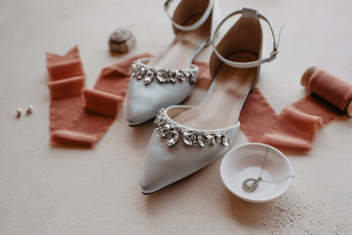 Photographers Jackson Hole capture close up of bridal shoes and earrings