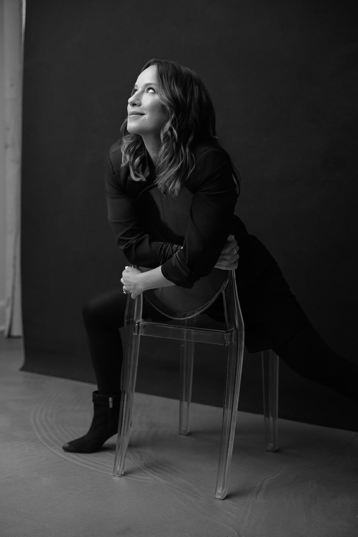 dina-hugging-chair-woman-black-outfit-editorial-portrait-by-elle-yeon